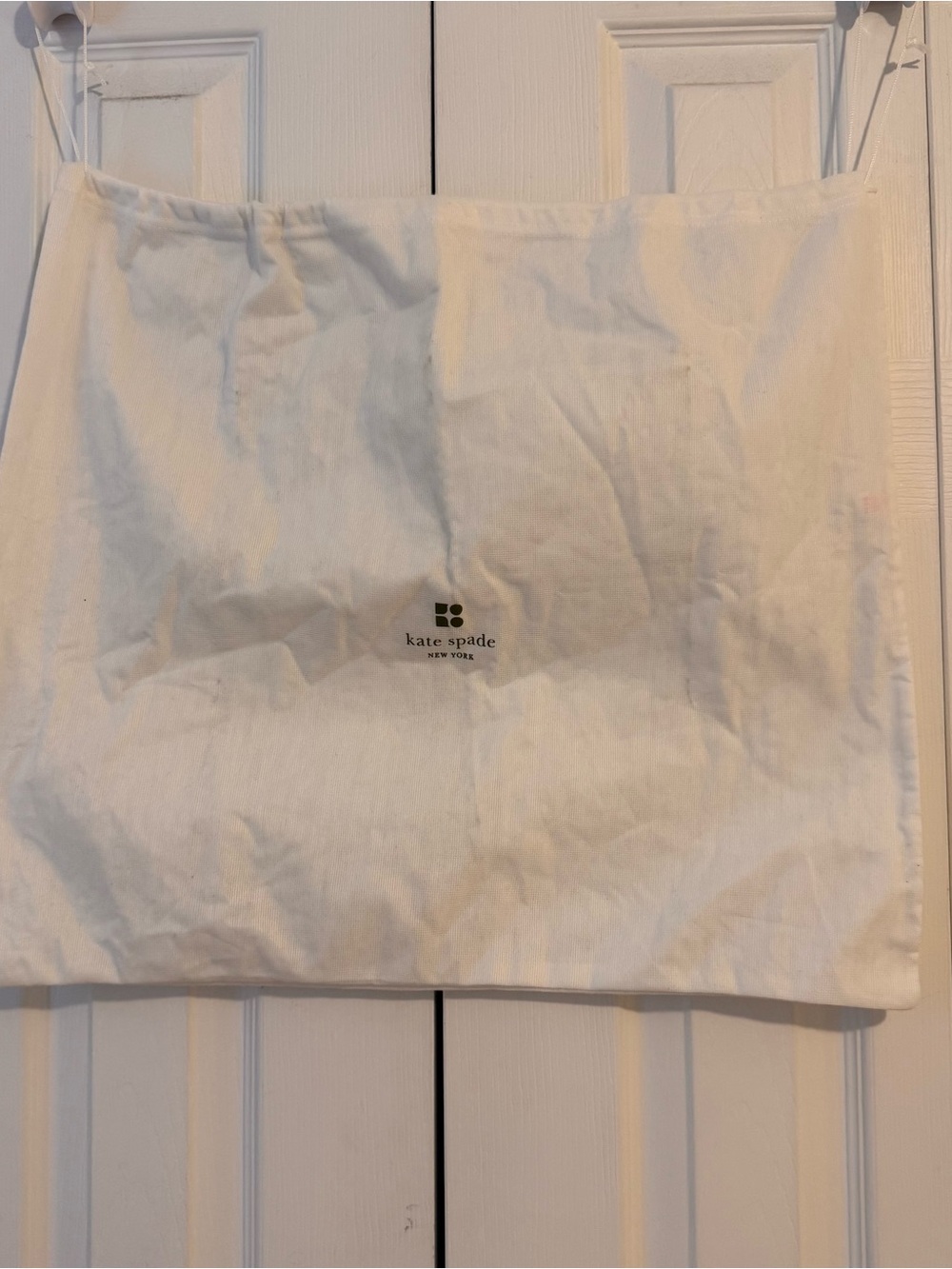 kate spade cream and black logo dust bag